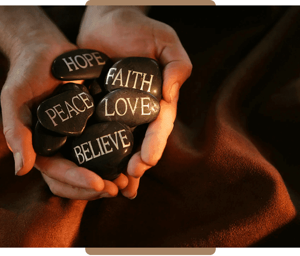 Hands holding stones with positive words