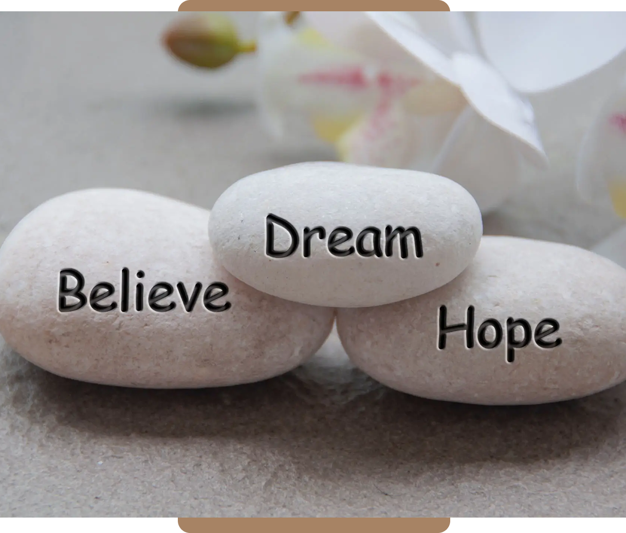 Stacked stones with the words Dream, Believe, and Hope.